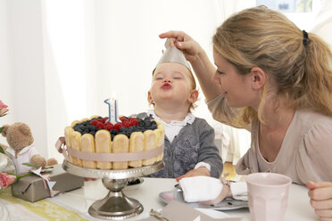 Mother and daughter celebrating little girl's first birthday with self-made fancy cake - FSF000246