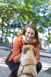 Portrait of smiling woman with her dog - JFEF000509