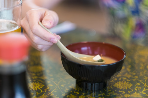 Young woman eating Japanese miso soup stock photo