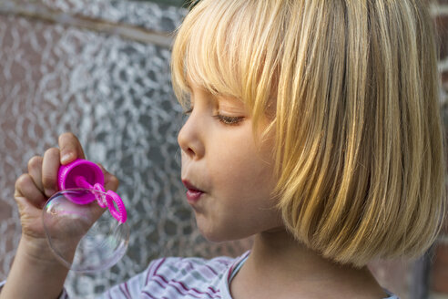 Porträt eines kleinen Mädchens, das Seifenblasen macht - JFEF000492