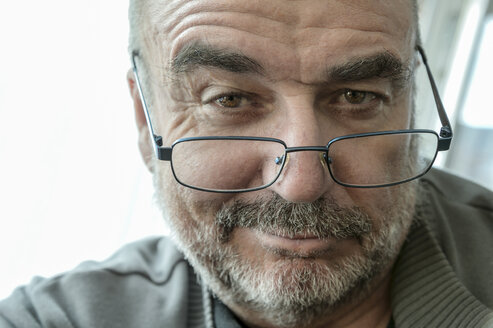 Portrait of smiling senier man wearing reading glasses - FRF000017