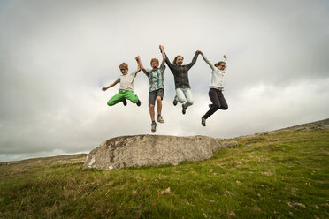 United Kingdom, England, Cornwall, Children jumping from stone - PAF001023