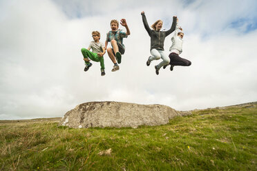 United Kingdom, England, Cornwall, Children jumping from stone - PAF001025