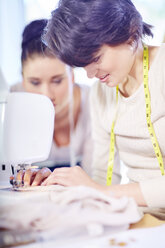 Seamstress working on sewing machine - ZEF001693