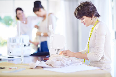 Seamstress working on sewing machine - ZEF001695