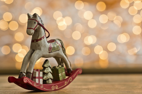 Christmas rocking horse in front of points of light stock photo