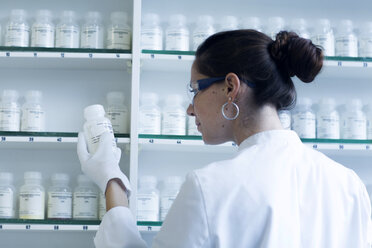 Young female scientist working in a chemical lab - SGF000894