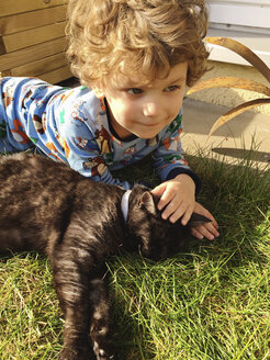 Boyr lying in grass with black cat - AFF000141