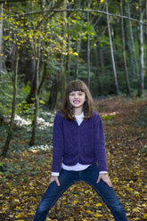 Girl standing in autumnal forest - LVF002082