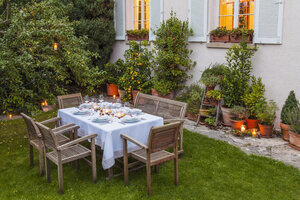 Autumnal laid table in garden in the evening - WDF002730