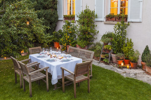 Autumnal laid table in garden in the evening - WDF002730