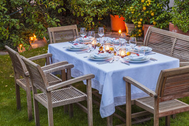 Autumnal laid table in garden in the evening - WDF002731