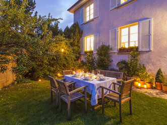 Autumnal laid table in garden in the evening - WDF002734