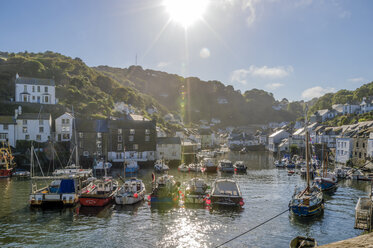 UK, Cornwall, Polperro, fishing boats in harbor in back light - FRF000036