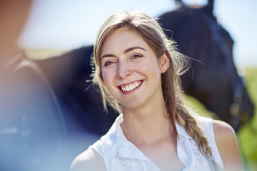 Lächelnde junge Frau mit Pferd - ZEF001702