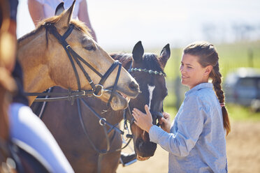 Smiling woman on riding ring with horses - ZEF001719