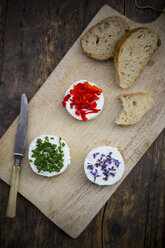 Goat cheese with nasturtium, chives and lavender on chopping board - LVF002381