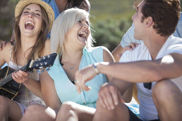 Friends with guitar having fun outdoors - ZEF002449