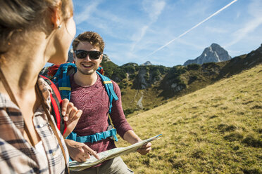 Austria, Tyrol, Tannheimer Tal, young couple hiking with map - UUF002423