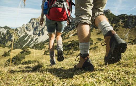 Austria, Tyrol, Tannheimer Tal, close-up of young couple hiking - UUF002465