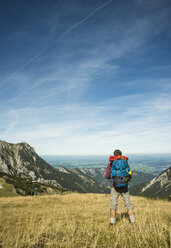 Austria, Tyrol, Tannheimer Tal, young hiker looking at view - UUF002440