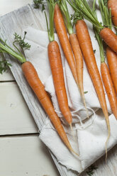 Carrots, Daucus carota, with greens on cloth - SBDF001413