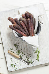 Pail of prepared Purple Haze and peeler on wooden board - SBDF001424