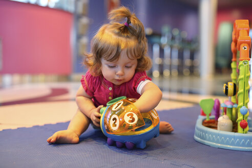 Baby girl playing with toys in a playroom of cruise liner - SHKF000080