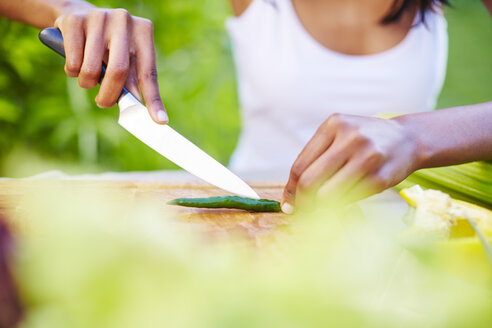 Young woman preparing healthy meal in garden - ZEF001788