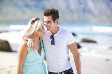 Happy young couple walking on the beach - ZEF002365