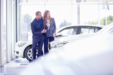 Smiling couple at car dealer - ZEF002018