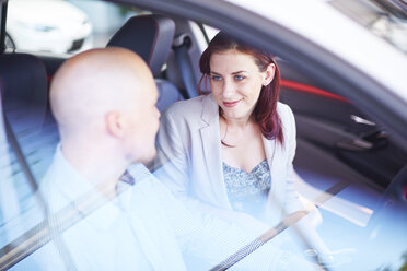 Couple at car dealer examing car interior - ZEF002031