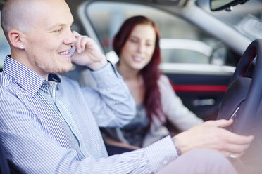 Couple at car dealer inside car - ZEF002033