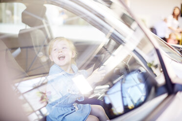 Happy girl at car dealer inside car - ZEF002064