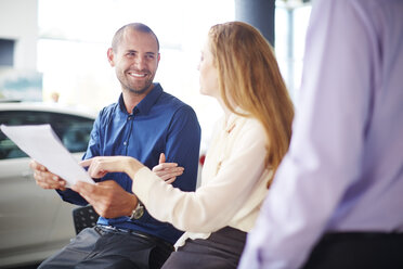 Couple at car dealer buying new car - ZEF002071