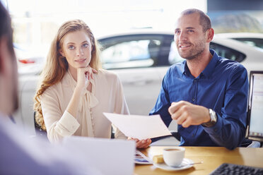 Couple at car dealer buying new car - ZEF002073