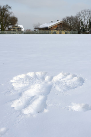 Germany, Bavaria, Chiemsee, island Frauenchiemsee, snow angel on meadow stock photo