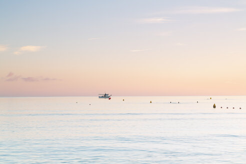 Spain, Balearic Islands, Majorca, Three people swimming in the sea in the morning light - MSF004339