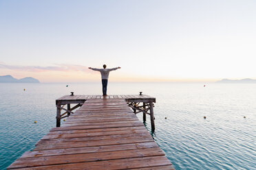 Spain, Balearic Islands, Majorca, one teenage boy standing on a jetty in the morning - MSF004343