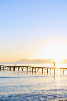 Spain, Balearic Islands, Majorca, man jogging on a jetty at sunrise - MSF004347