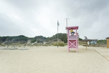 Spain, Balearic Islands, Majorca, one teenage boy sitting on a lifeguard stand - MSF004378