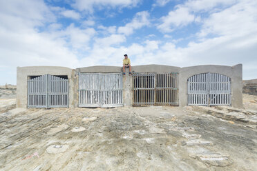 Spain, Balearic Islands, Majorca, one teenage boy sitting on fishing storage hut - MSF004366