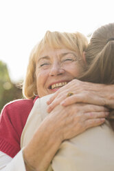 Portrait of happy senior woman hugging ger granddaughter - UUF002568