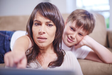 Mother and son at home looking at laptop - ZEF002297