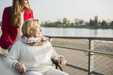 Granddaughter assisting her grandmother sitting in wheelchair - UUF002602