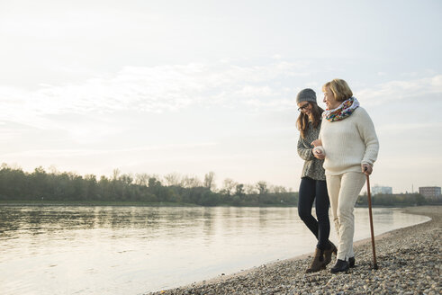 Young woman assisting her grandmother walking - UUF002617