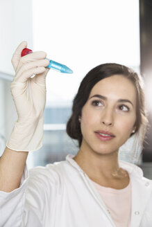 Female scientist checking test tube - FKF000868