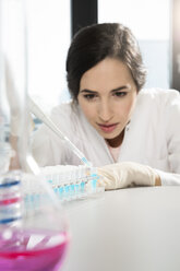 Female researcher working with test tubes in laboratory - FKF000837
