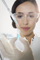 Female researcher working with test tubes in laboratory - FKF000839