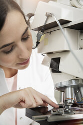 Female scientist working on microscope - FKF000847